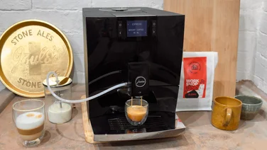 Jura C8 lead image on a worktop with a coffee being made