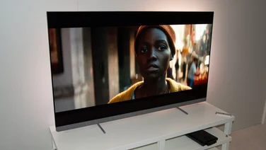 Left view of the Philips OLED+910 4K televisions displaying a scene from A Quiet Place: Day One
