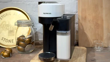Nespresso Vertuo Lattissima review coffee machine with full milk jug on a worktop