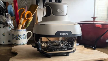 The Ninja Crispi on a chopping board in a kitchen