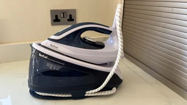 Tefal Express Essential SV6116 side view of iron and water container on a white worktop