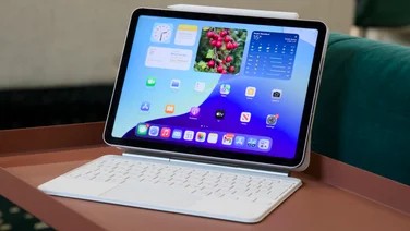 The M3 iPad Air (2025) - pictured in the Magic Keyboard case on a red coffee table