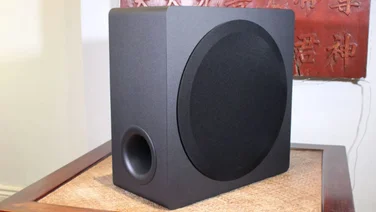 where_to_place_a_subwoofer_in_relation_to_a_soundbar_featured_image_lg_us95tr_sub subwoofer on a wooden floor