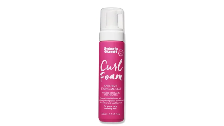 A bottle of Umberto Giannini Curl Foam on a white background