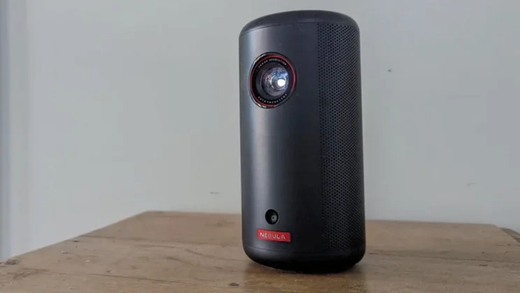 The Nebula Capsule 3 projector on a wooden table