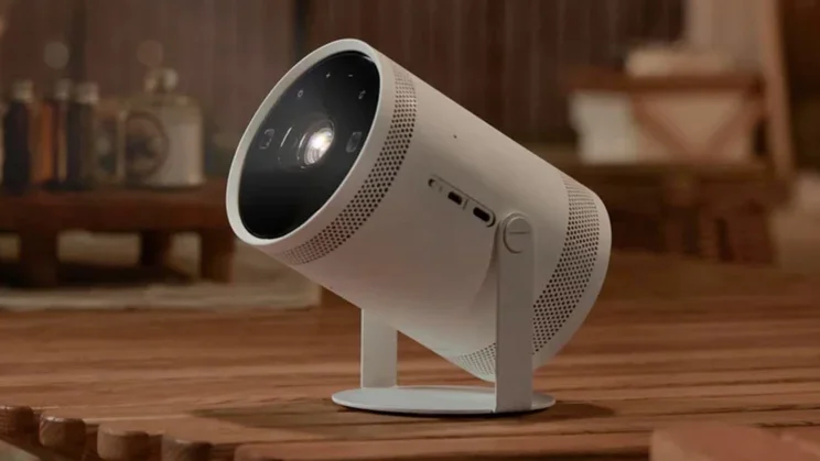 The Samsung Freestyle 2nd Gen projector on a wooden table