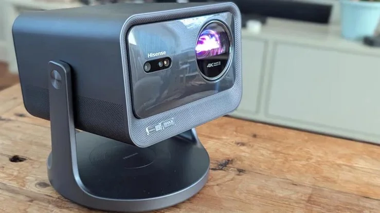 The Hisense C2 Pro projector on a wooden table