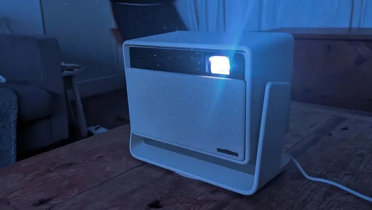 The XGIMI Horizon S Pro projector on a table in a dark room