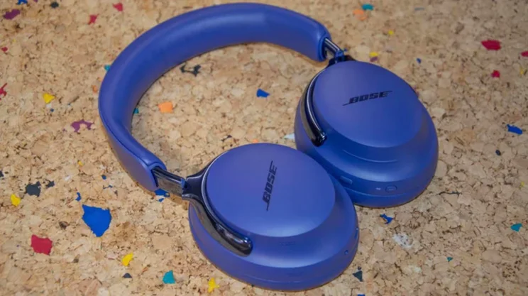 The Bose QuietComfort Ultra Headphones Gen 2 laid flat on a cork table