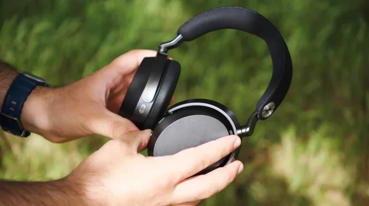 The Sennheiser Momentum 5 Wirelss being held by a reviewer
