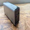 The Cuktech 15 Ultra power bank pictured on a wood table, showing a close up of the output ports