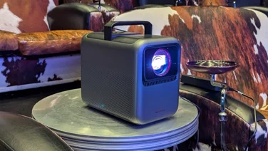 The Anker Nebula X1 projector pictured on a coffee table