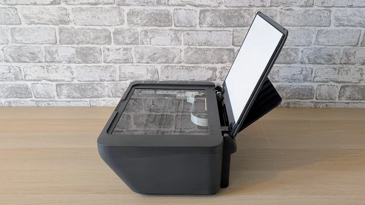 The Canon Pixma MG2551S pictured from the side with the scanner lid raised