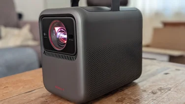 The Nebula X1 projector from the front on a wood coffee table