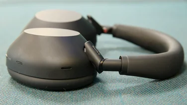 The Sony WH-1000XM6 headphones pictured on a green textured surface