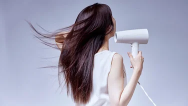How we test hair dryers: Our in-depth methodology lady blow drying her hair