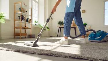 Cleaning jobs to keep your home pest free this summer lady vacuuming a rug