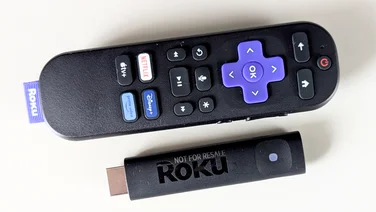 Roku Streaming Stick Plus and remote control from above on a white surface