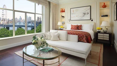 Suite at Savoy hotel London with bed glass coffee table and chaise