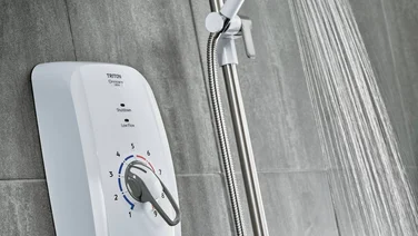 Triton electric shower with water running from spray