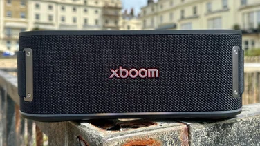 Front view of the LG xboom Bounce Bluetooth speaker on a wall outside buildings in Brighton