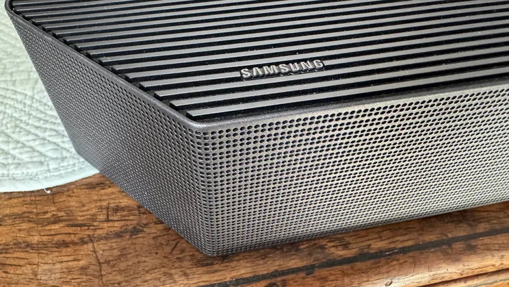 Close-up of the Samsung logo on the soundbar component of the Samsung HW-Q990F home audio system