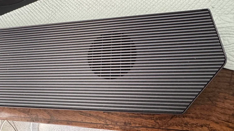Close-up view of one of the upfiring drivers built into the soundbar component of the Samsung HW-Q990F home audio system