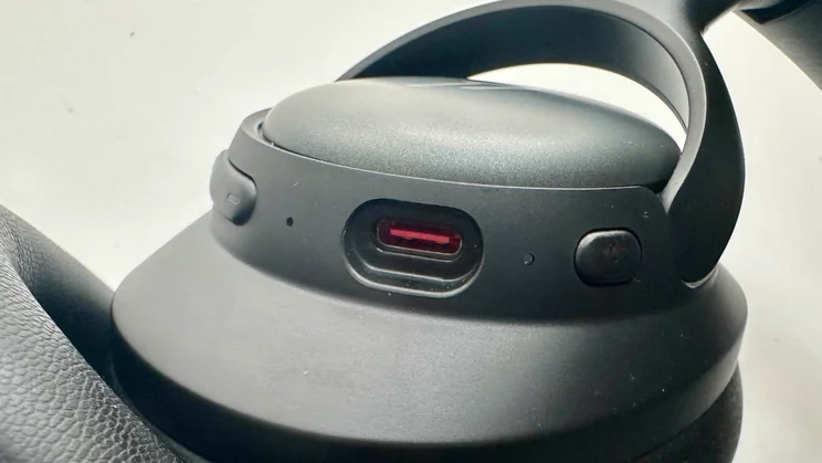 Close-up of the USB-C port and main control button on the 1MORE SonoFlow SE HQ31 over-ear headphones