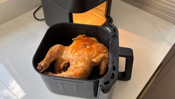 A cooked chicken inside the drawer of the Instant Pot Vortex Compact 5L air fryer