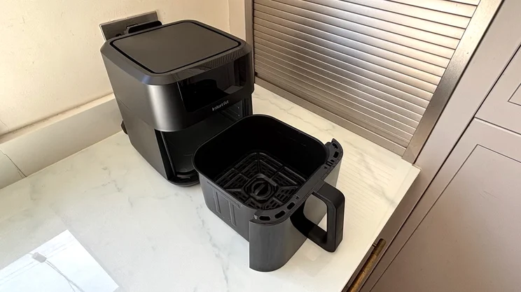 The Instant Pot Vortex Compact 5L air fryer with drawer pulled out, on a kitchen counter