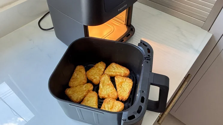 Cooked hash browns inside the drawer of the Instant Pot Vortex Compact 5L air fryer