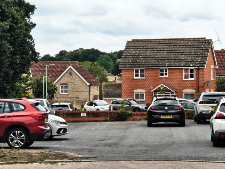 6x zoom of a close of houses with cars parked out front