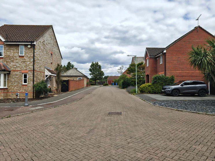 An empty road with houses on both sides