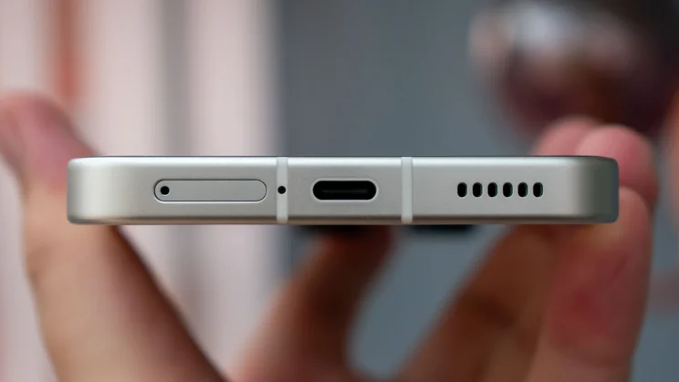 Nothing Phone (3) in hand, showing the bottom edge and charging port