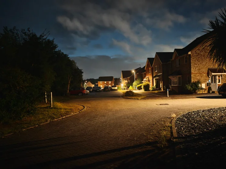 A quiet close at night with cars parked in front of the houses
