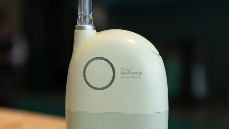 A close up of the power button of the Oclean AirPump A10 Water Flosser