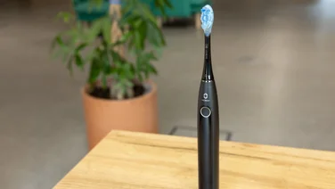 The Oclean X Pro 20 toothbrush on a table in an office