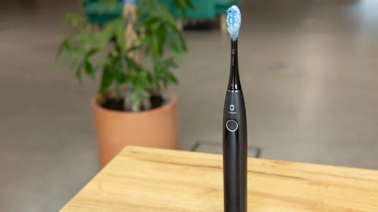 The Oclean X Pro 20 toothbrush on a table in an office