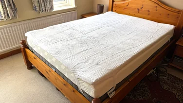 The Origin Contour mattress topper on a bed