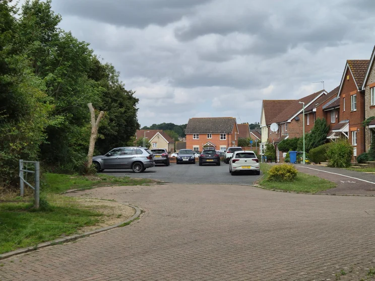 2x zoom of houses with cars parked out front