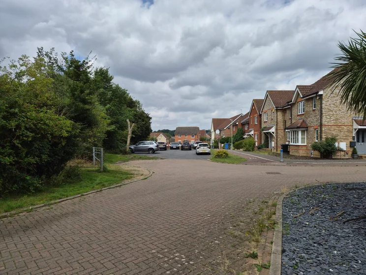 A quiet close of houses with cars parked out front