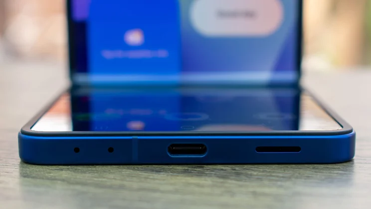 Samsung Galaxy Z Flip 7 folded on a desk, close up of the bottom edge and charging port