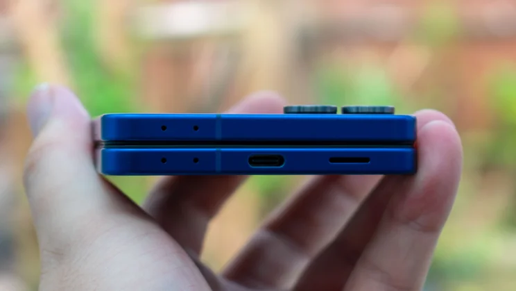 Samsung Galaxy Z Flip 7 folded in hand, showing the bottom edge and charging port