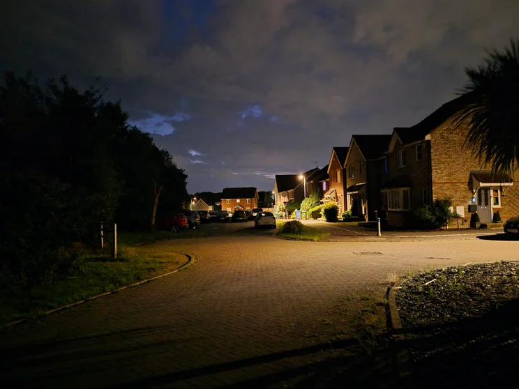 A quiet close at night, cars parked in front of the houses