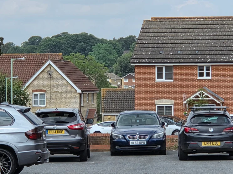 10x zoom of houses with cars parked out front