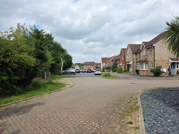 A close of houses with cars parked out front