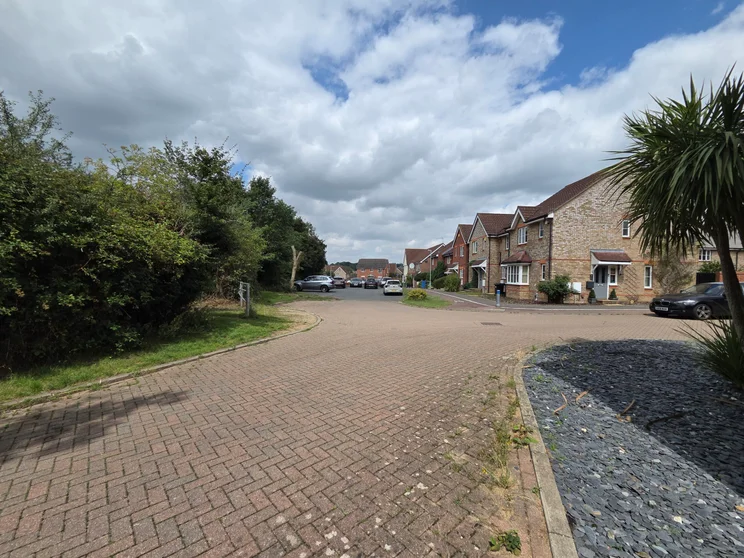 Ultrawide shot of a close of houses with cars parked out front