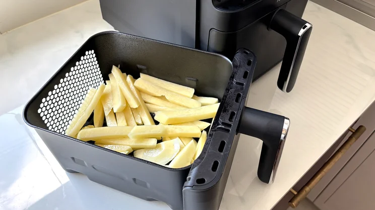 Uncooked chips inside a drawer of the Tower Vortx 11 Litre Dual Layer air fryer