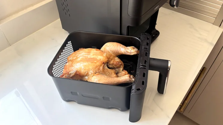 A cooked chicken inside the drawer of the Tower Vortx 11 Litre Dual Layer air fryer