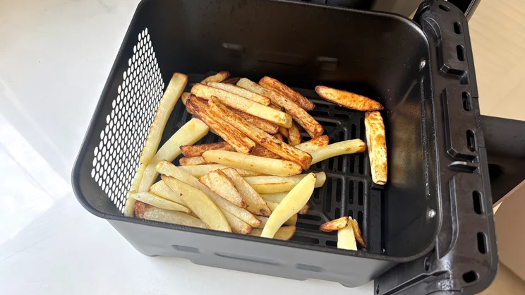 Cooked chips inside a drawer of the Tower Vortx 11 Litre Dual Layer air fryer